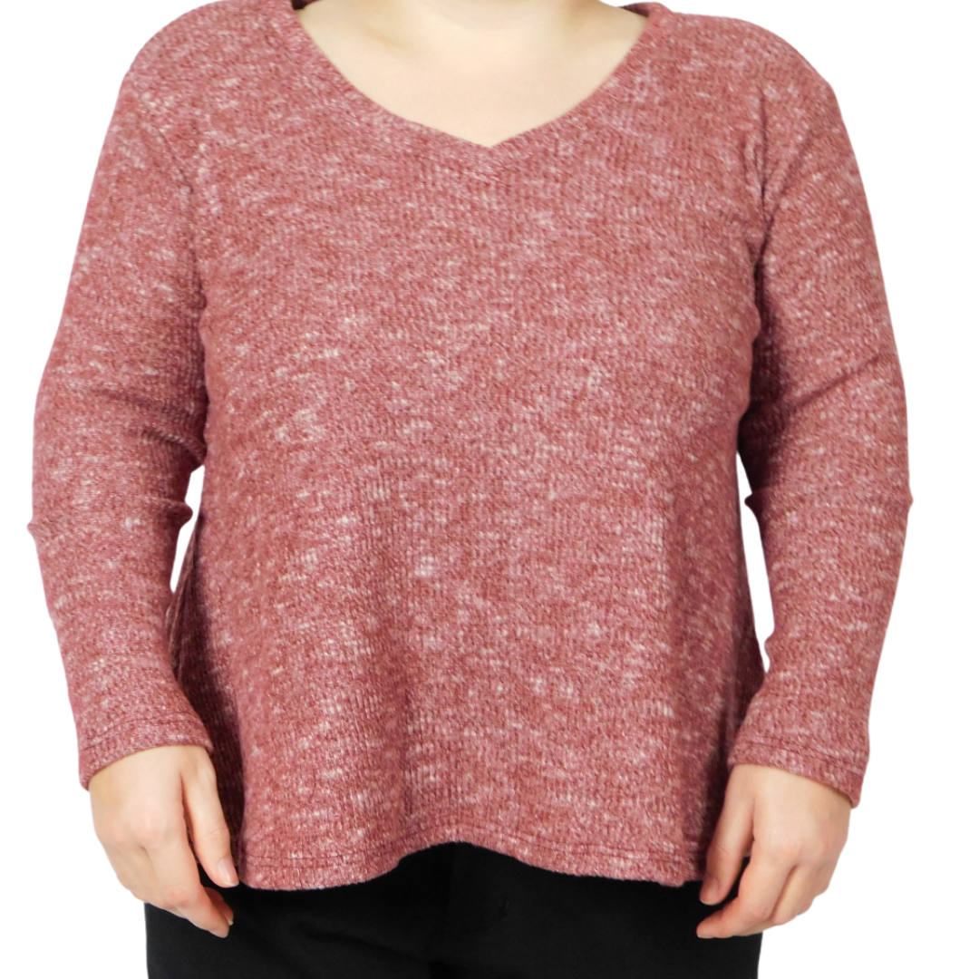 A little woman wearing a red long-sleeve knit sweater with a V-neck, paired with black pants, against a plain white background